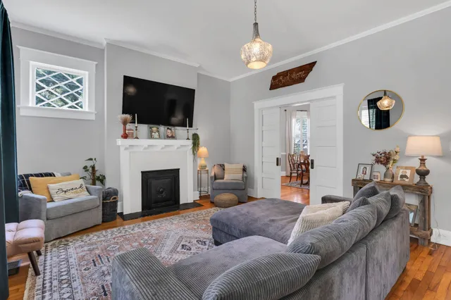 a living room with furniture a flat screen tv and a fireplace
