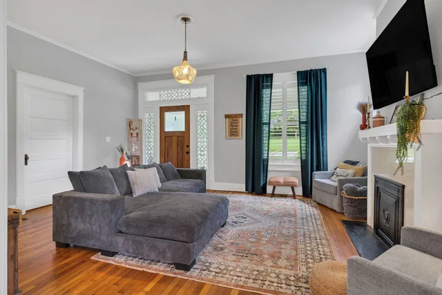 a view of a dining room with furniture and chandelier