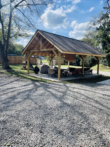 a view of a house with a yard and deck