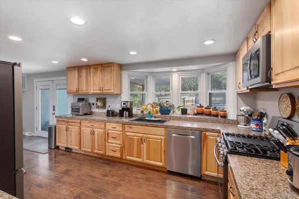 a kitchen with sink a stove and cabinets