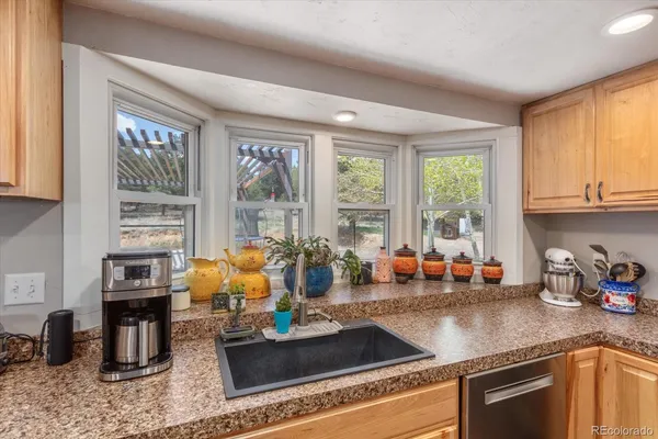 a kitchen with sink refrigerator and window
