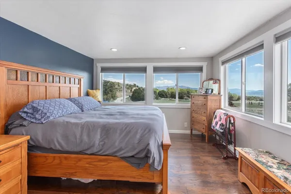 a bedroom with a bed and a large window