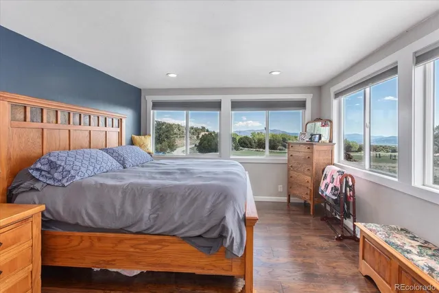 a bedroom with a bed and a large window