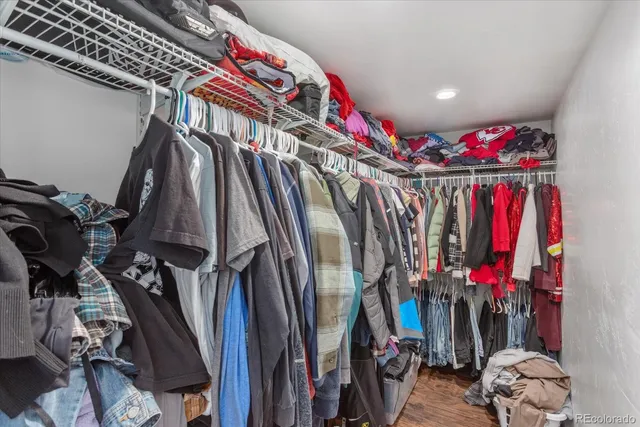 a view of walk in closet with clothes