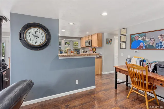 a view of a dining room with furniture and a large window