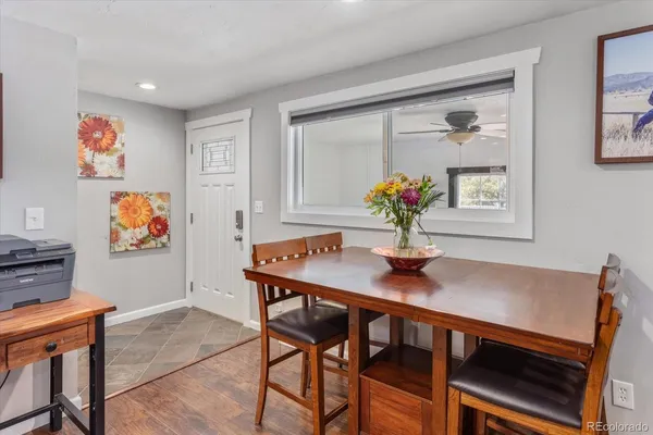 a view of a dining room with furniture wooden floor and a chandelier
