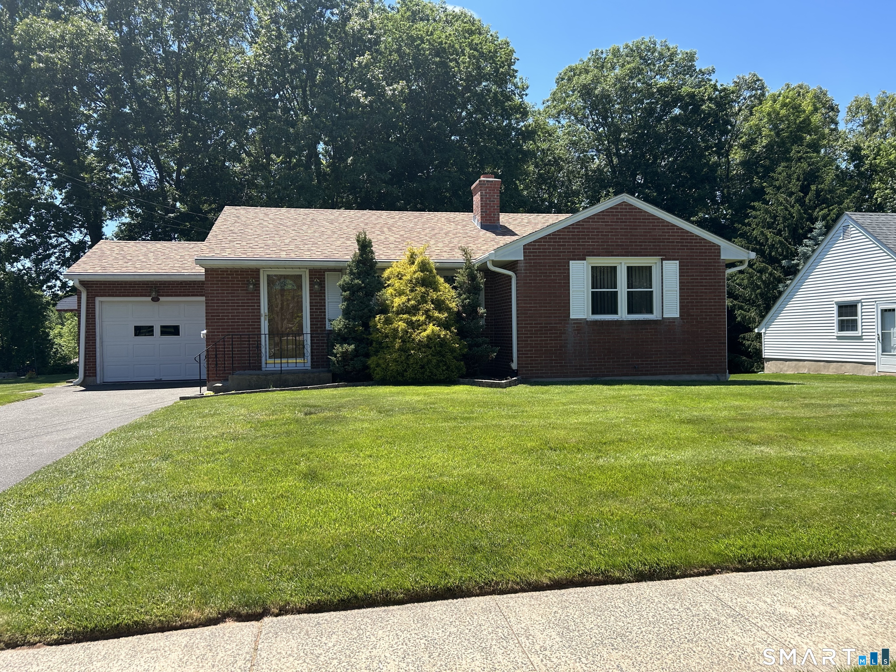 13 Walnut Lane Wallingford, CT 06492 - Photo 2 of 27 a front view of a house with a garden