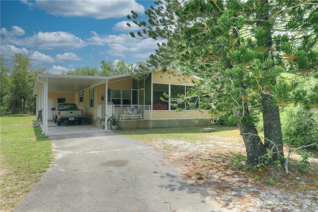 5519 95th Street Sebastian, FL 32958 - Photo 17 of 35 a view of a house with backyard porch and sitting area