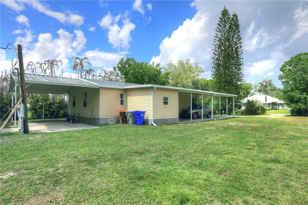 a view of a house with backyard and porch