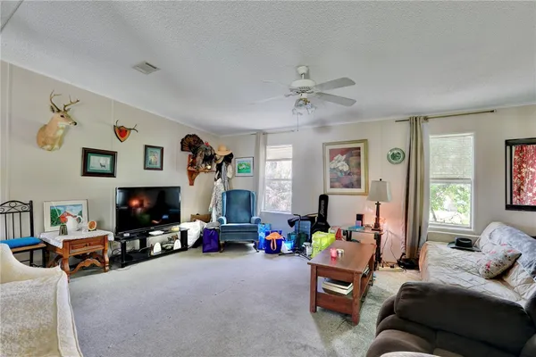a bedroom with furniture and a large window