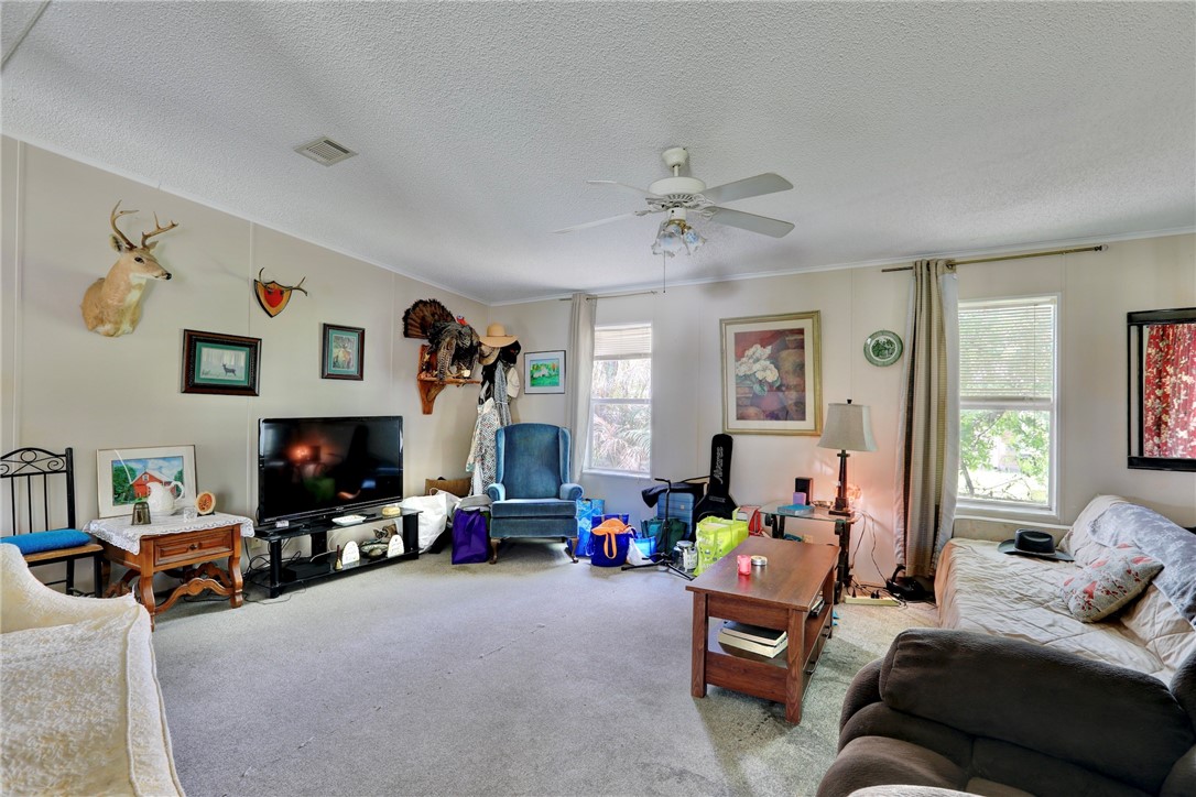 5519 95th Street Sebastian, FL 32958 - Photo 20 of 35 a living room with furniture and a flat screen tv