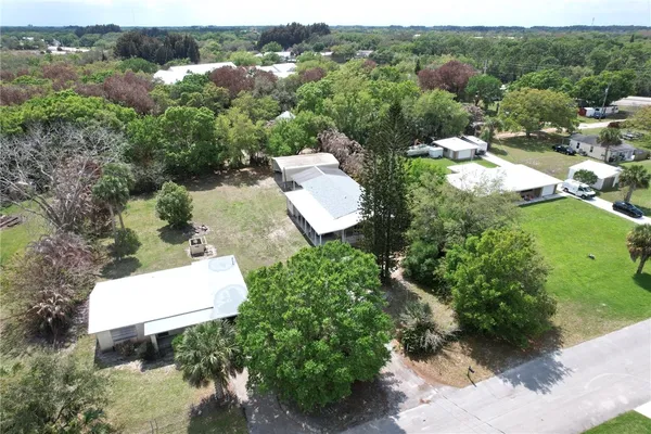 an aerial view of a house with a yard and lake view