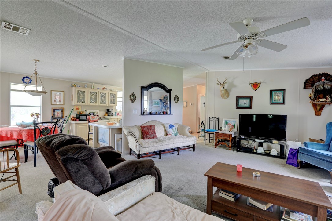 5519 95th Street Sebastian, FL 32958 - Photo 23 of 35 a living room with furniture a flat screen tv and a window