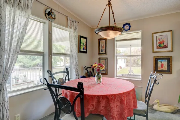 a view of a dining room with furniture and window