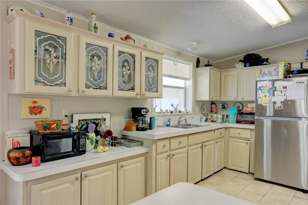 a kitchen with stainless steel appliances a refrigerator and a stove top oven