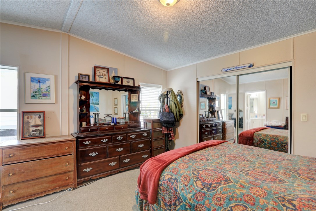 5519 95th Street Sebastian, FL 32958 - Photo 29 of 35 a bedroom with a bed and a large mirror