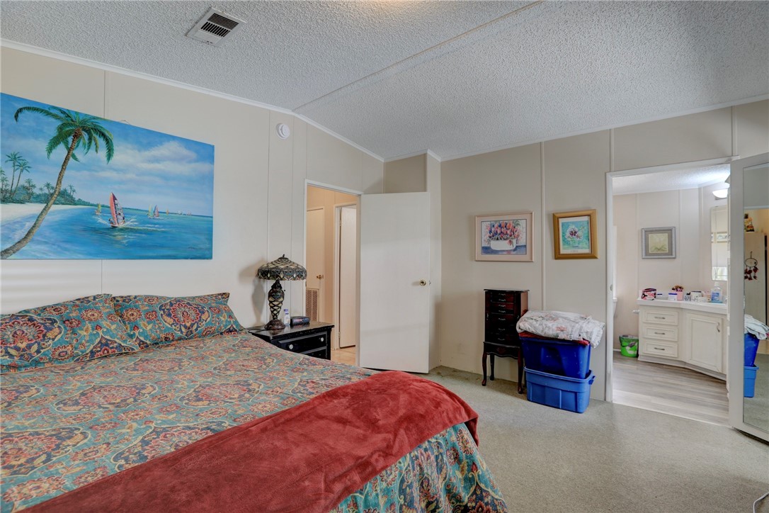 5519 95th Street Sebastian, FL 32958 - Photo 30 of 35 a bedroom with a bed and wooden floor