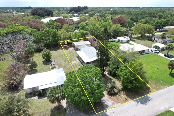 an aerial view of a house with yard