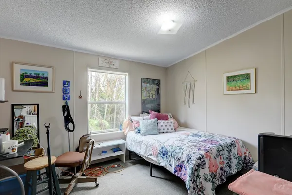 a bedroom with a bed and a bookshelf