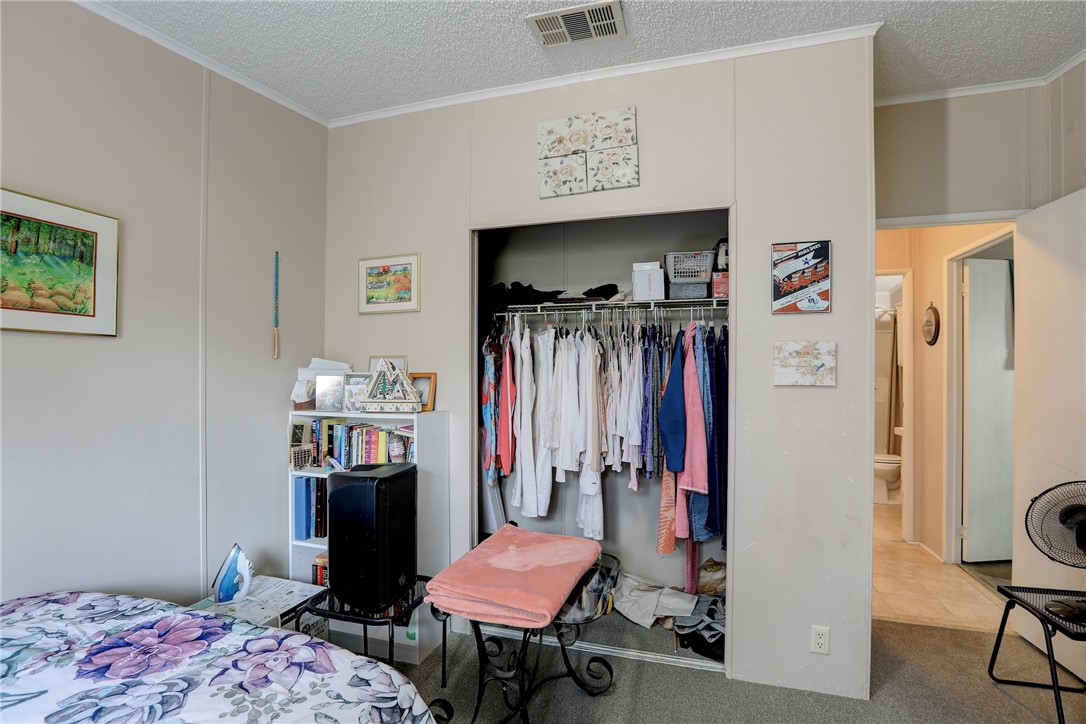 5519 95th Street Sebastian, FL 32958 - Photo 33 of 35 a bedroom with a bed and a bookshelf