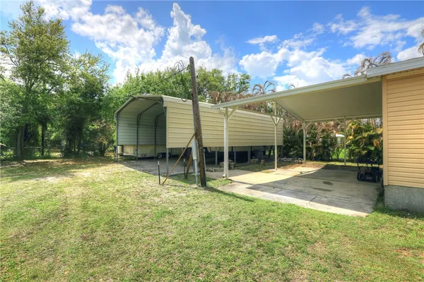 a view of a house with a backyard and a tree