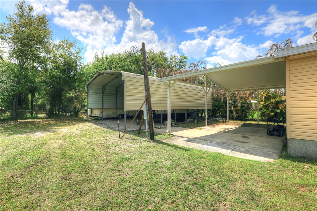 5519 95th Street Sebastian, FL 32958 - Photo 6 of 35 a view of a house with a backyard and a tree