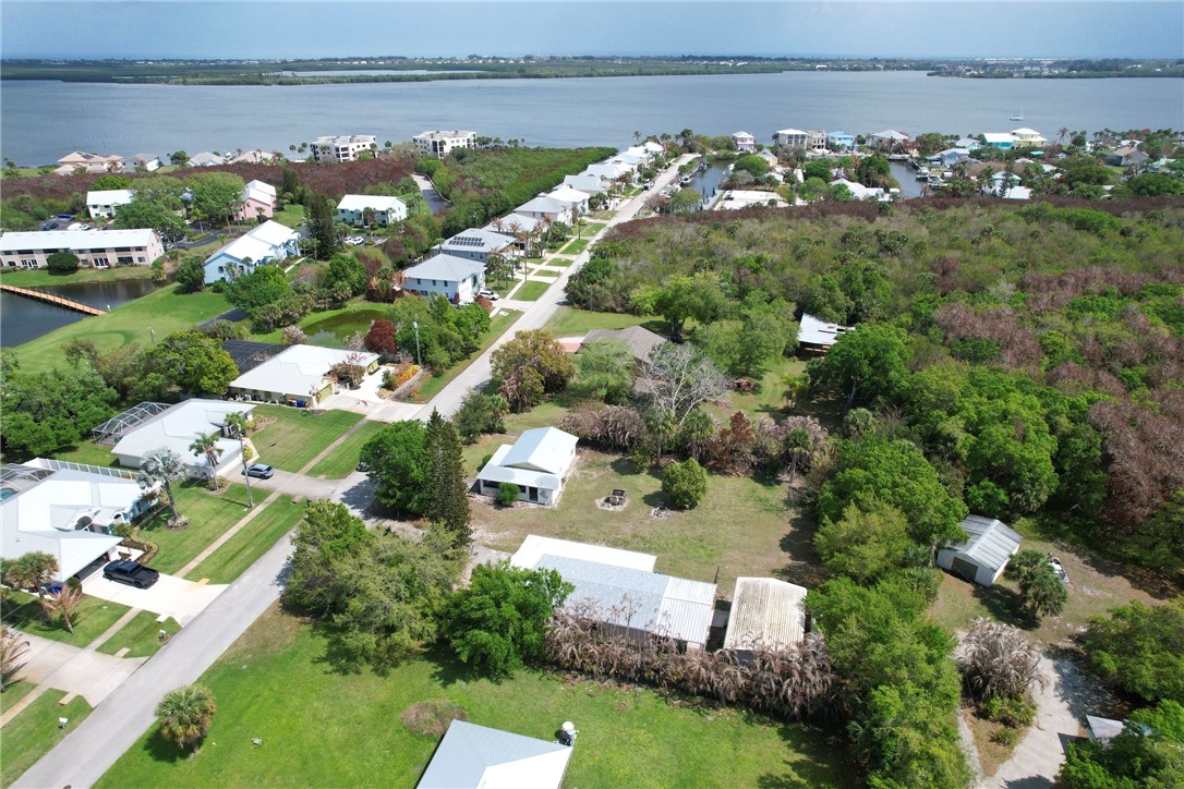 5519 95th Street Sebastian, FL 32958 - Photo 9 of 35 an aerial view of a house with a garden and lake view