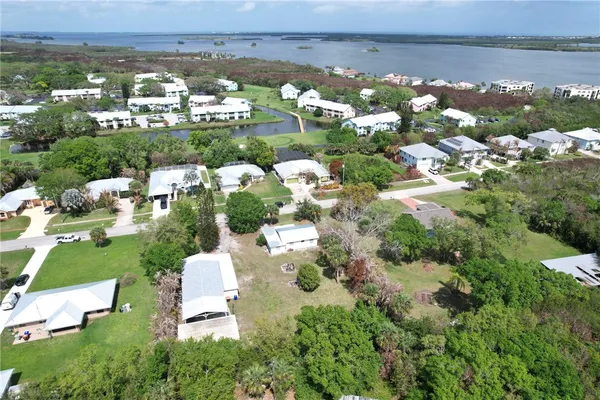 an aerial view of a houses with a lake view