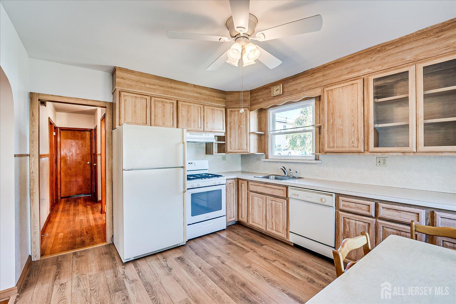 92 Lake View Boulevard Edison, NJ 08817 - Photo 14 of 39 a kitchen with stainless steel appliances granite countertop a refrigerator a sink dishwasher a stove with wooden cabinets and floor