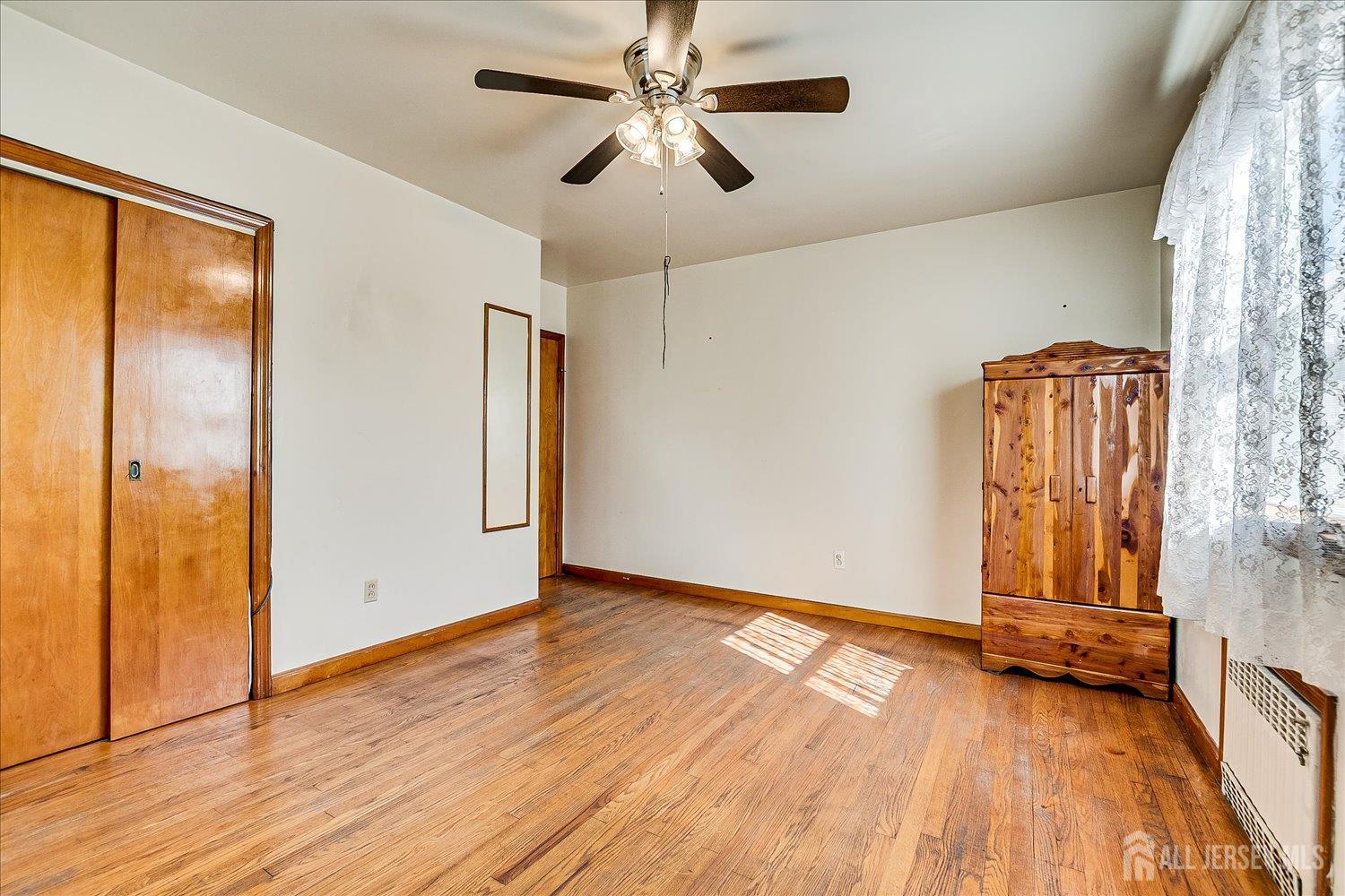 92 Lake View Boulevard Edison, NJ 08817 - Photo 17 of 39 wooden floor in an empty room with a window