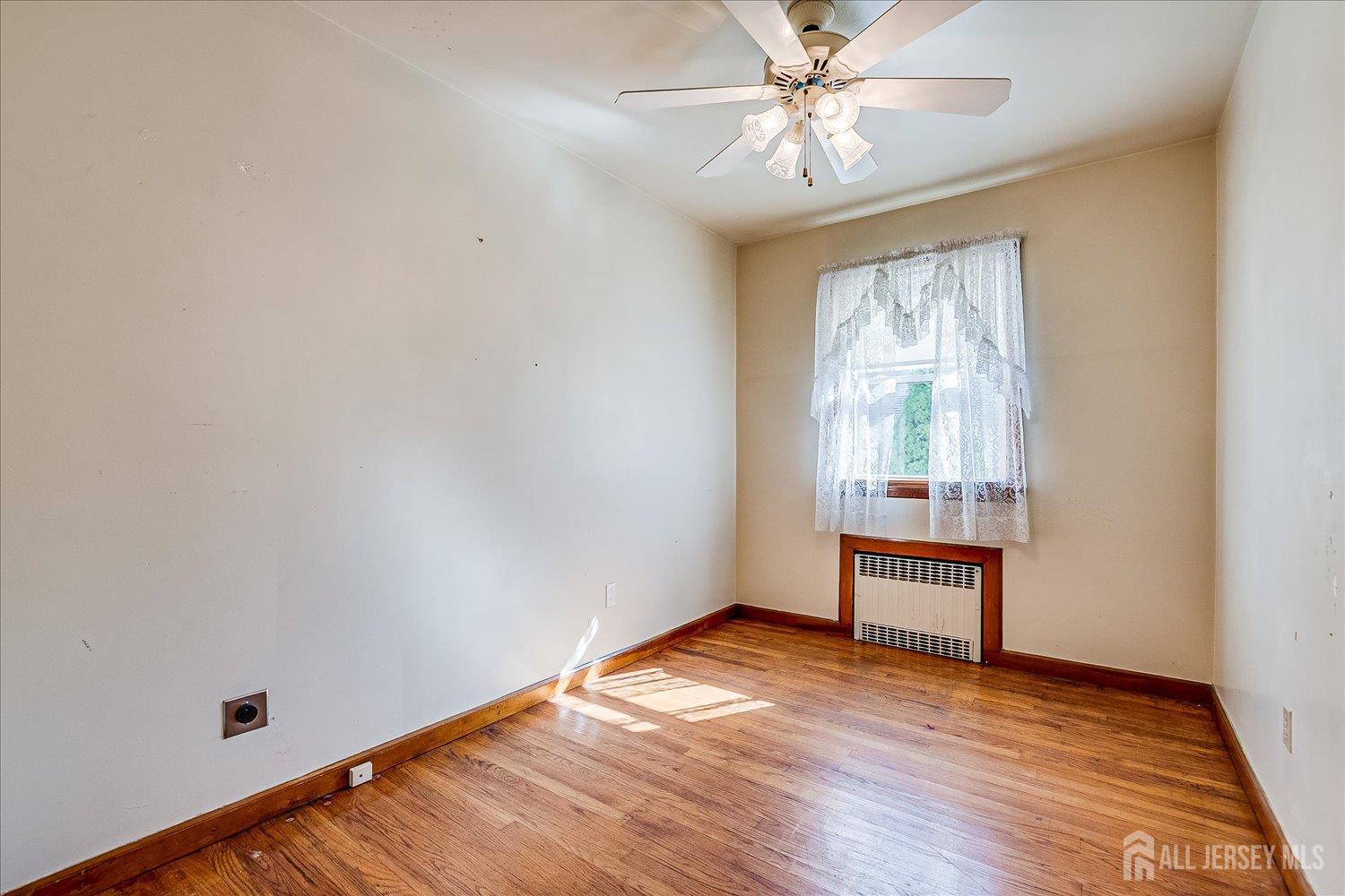 92 Lake View Boulevard Edison, NJ 08817 - Photo 22 of 39 wooden floor in an empty room with a window