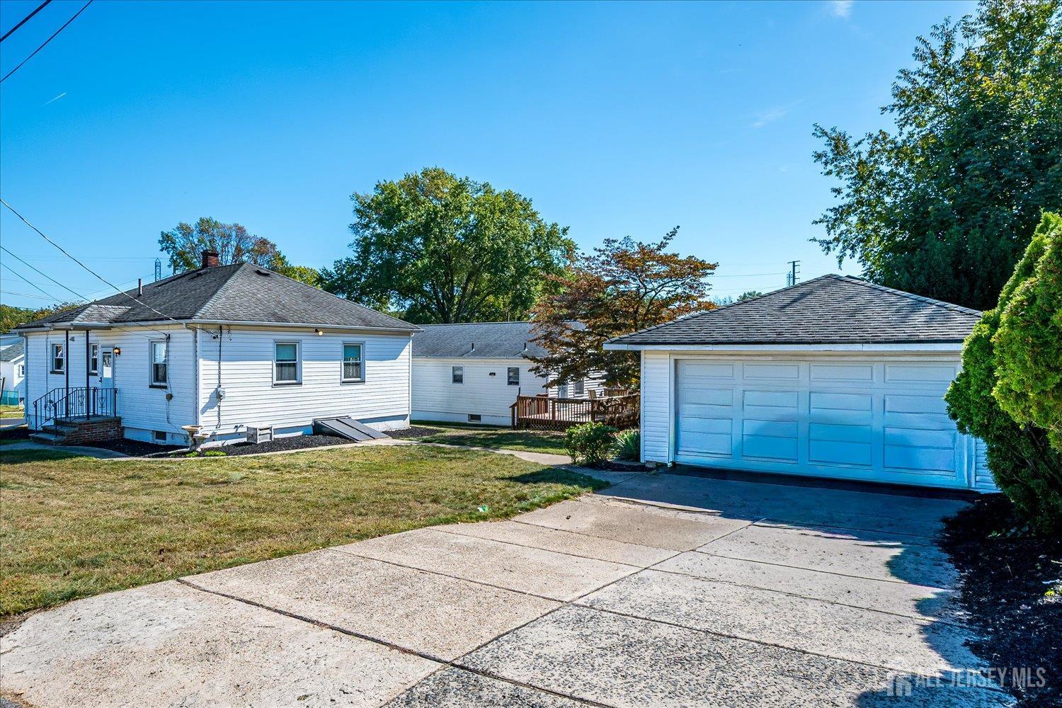 92 Lake View Boulevard Edison, NJ 08817 - Photo 3 of 39 a front view of a house with a yard and garage