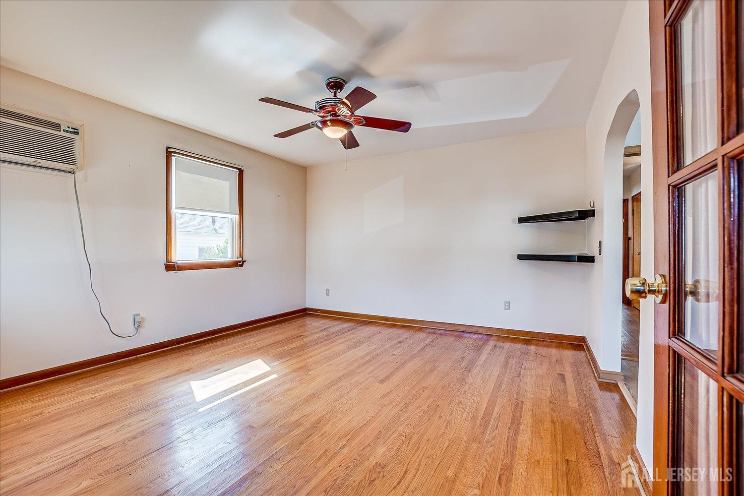 92 Lake View Boulevard Edison, NJ 08817 - Photo 10 of 39 a view of a room with wooden floor staircase and a ceiling fan