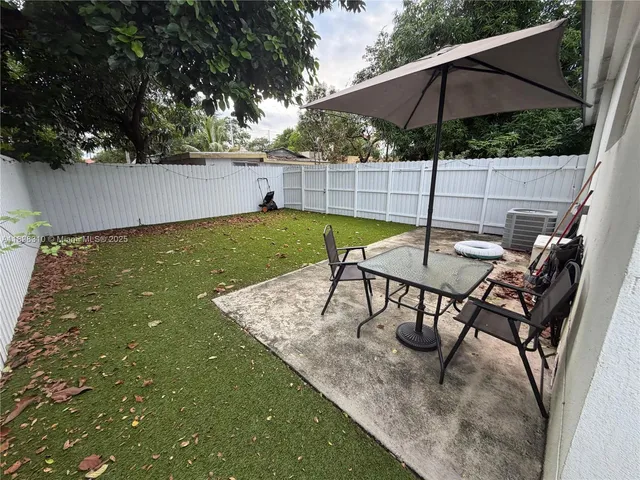 swimming pool view with a seating space