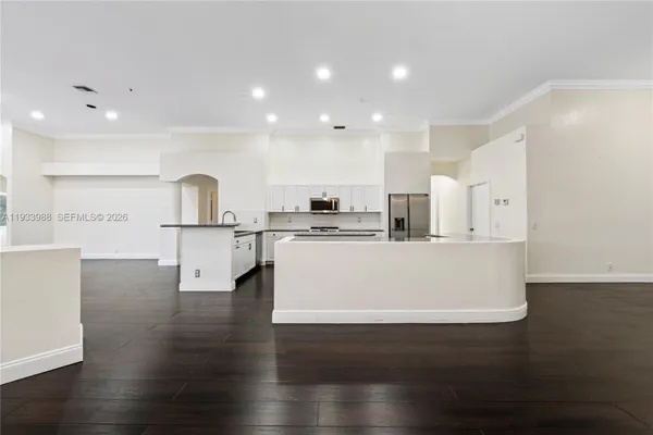 a kitchen with granite countertop white cabinets and white appliances
