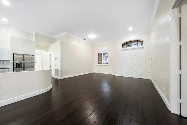 a kitchen with white cabinets appliances and sink