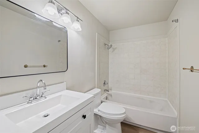 a bathroom with a sink mirror toilet and bathtub