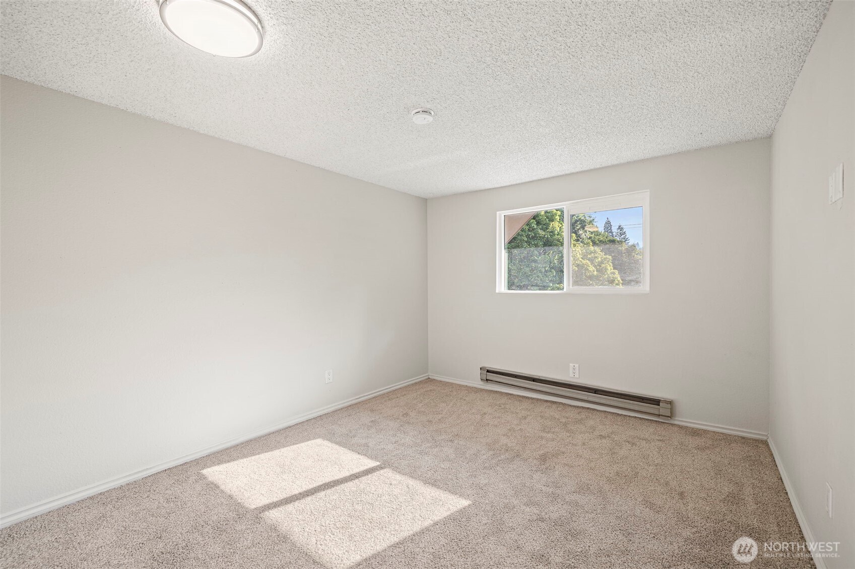 210 Southwest Clark Street, Unit A202 Issaquah, WA 98027 - Photo 17 of 28 an empty room with windows
