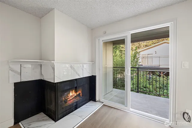 a living room with a fireplace and a floor to ceiling window