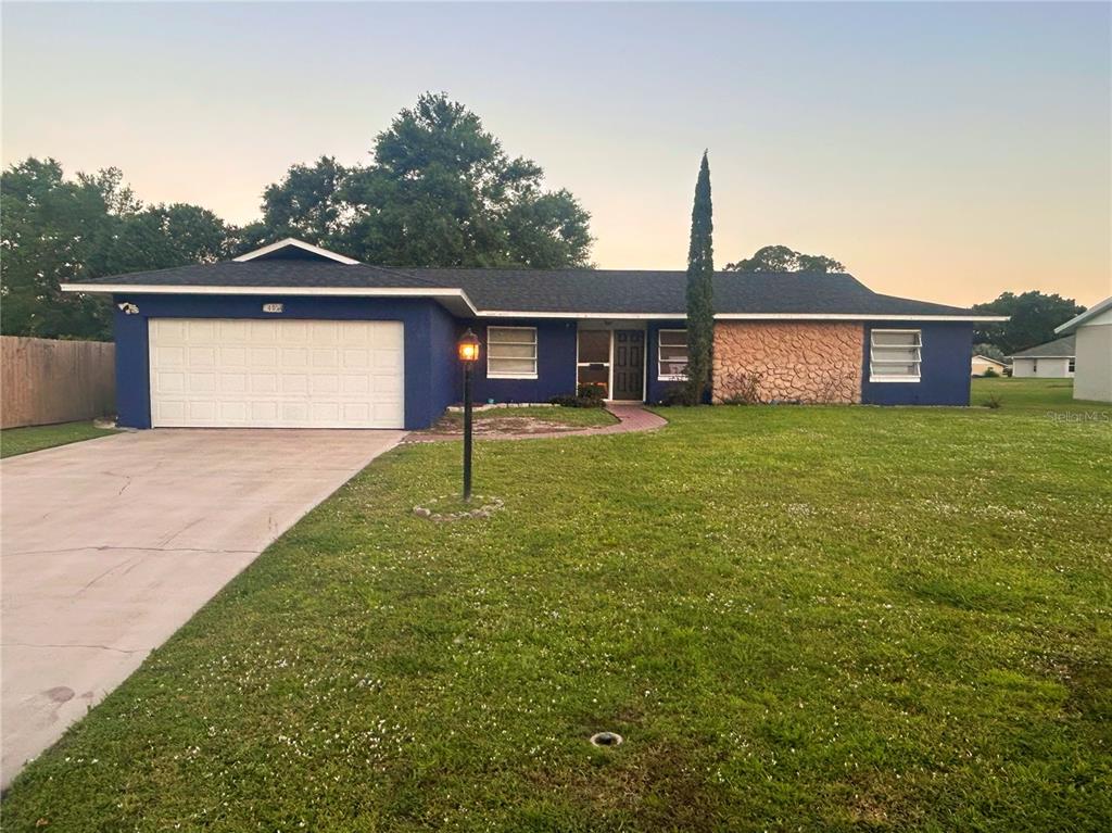4027 Bianca Street Sebring, FL 33872 - Photo 1 of 22 a front view of a house with yard and green space