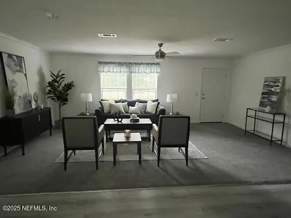 a large kitchen with granite countertop a stove a sink and a microwave