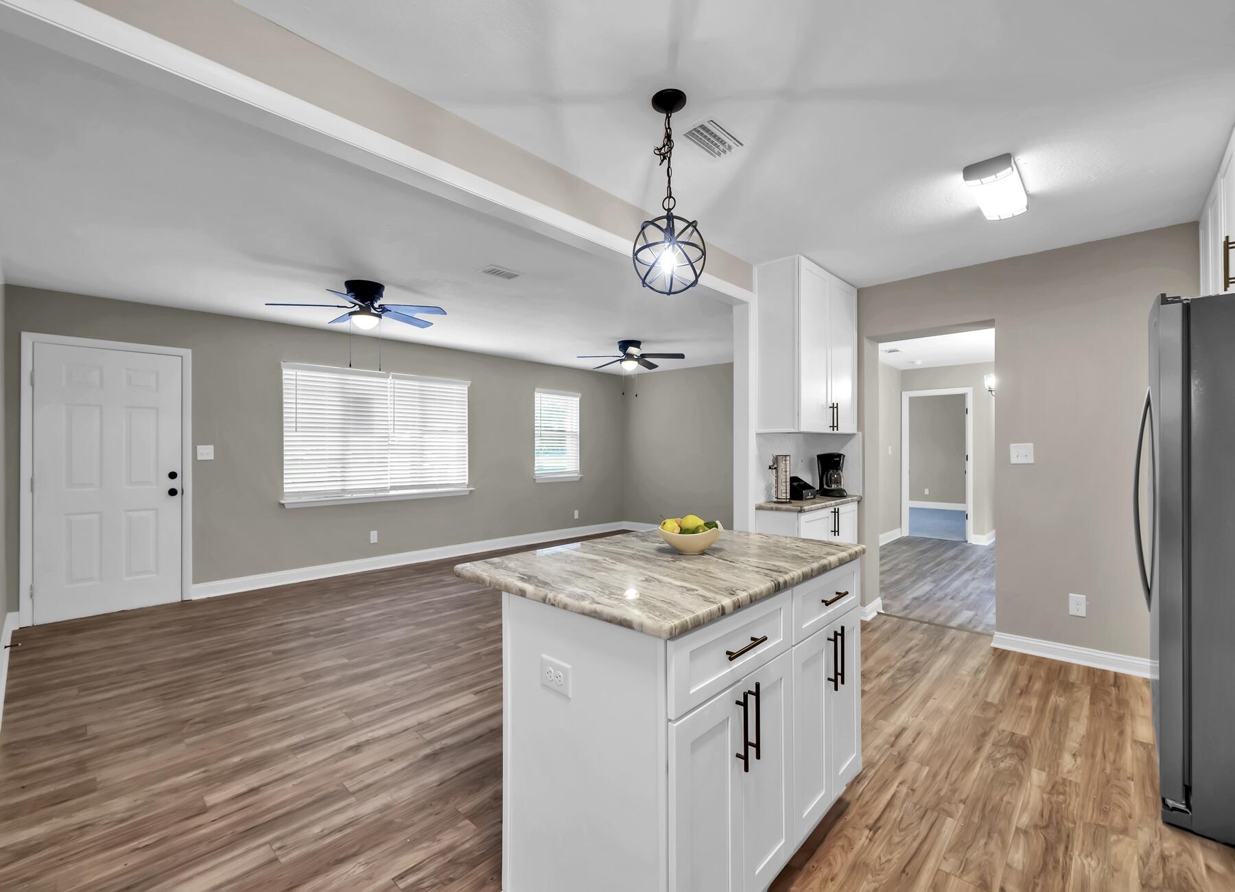 3102 Barnhill Road Crestview, FL 32539 - Photo 10 of 44 a view of a kitchen counter space and wooden floor