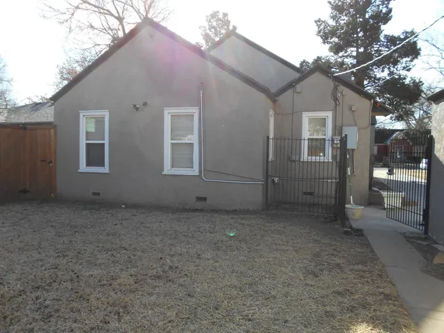 a view of a livingroom with wooden floor a fireplace and window