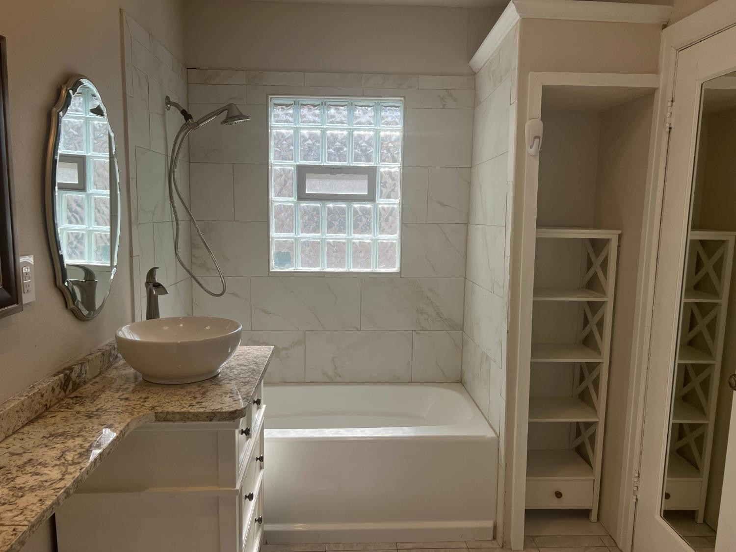 2518 25th Street Lubbock, TX 79410 - Photo 17 of 39 a bathroom with a sink toilet and shower