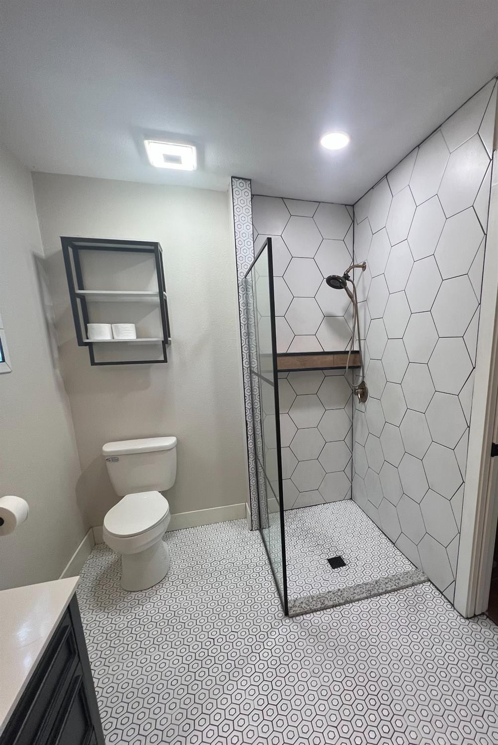 2518 25th Street Lubbock, TX 79410 - Photo 19 of 39 a bathroom with a shower a toilet and a sink