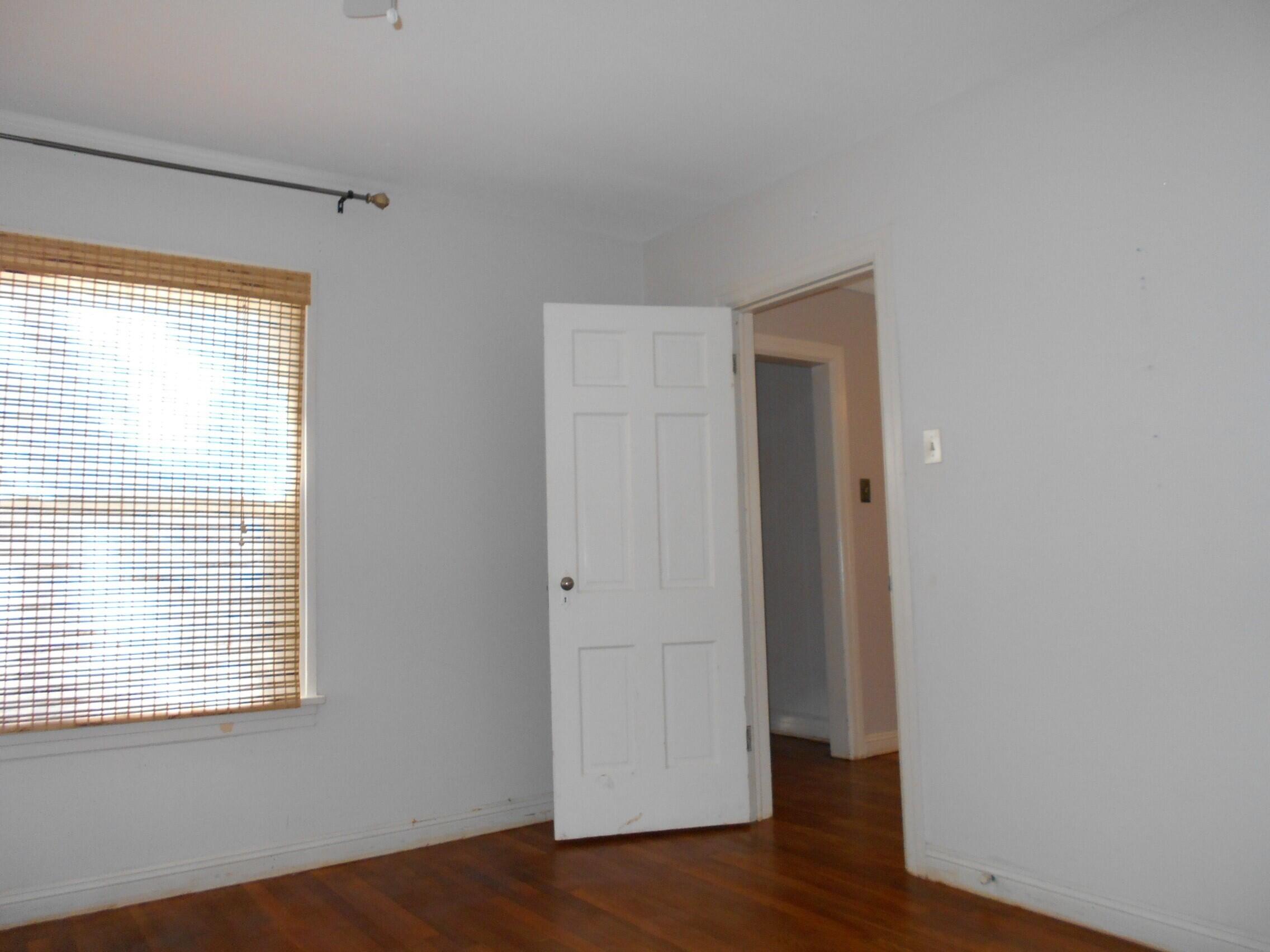 2518 25th Street Lubbock, TX 79410 - Photo 22 of 39 a view of an empty room with wooden floor and a window