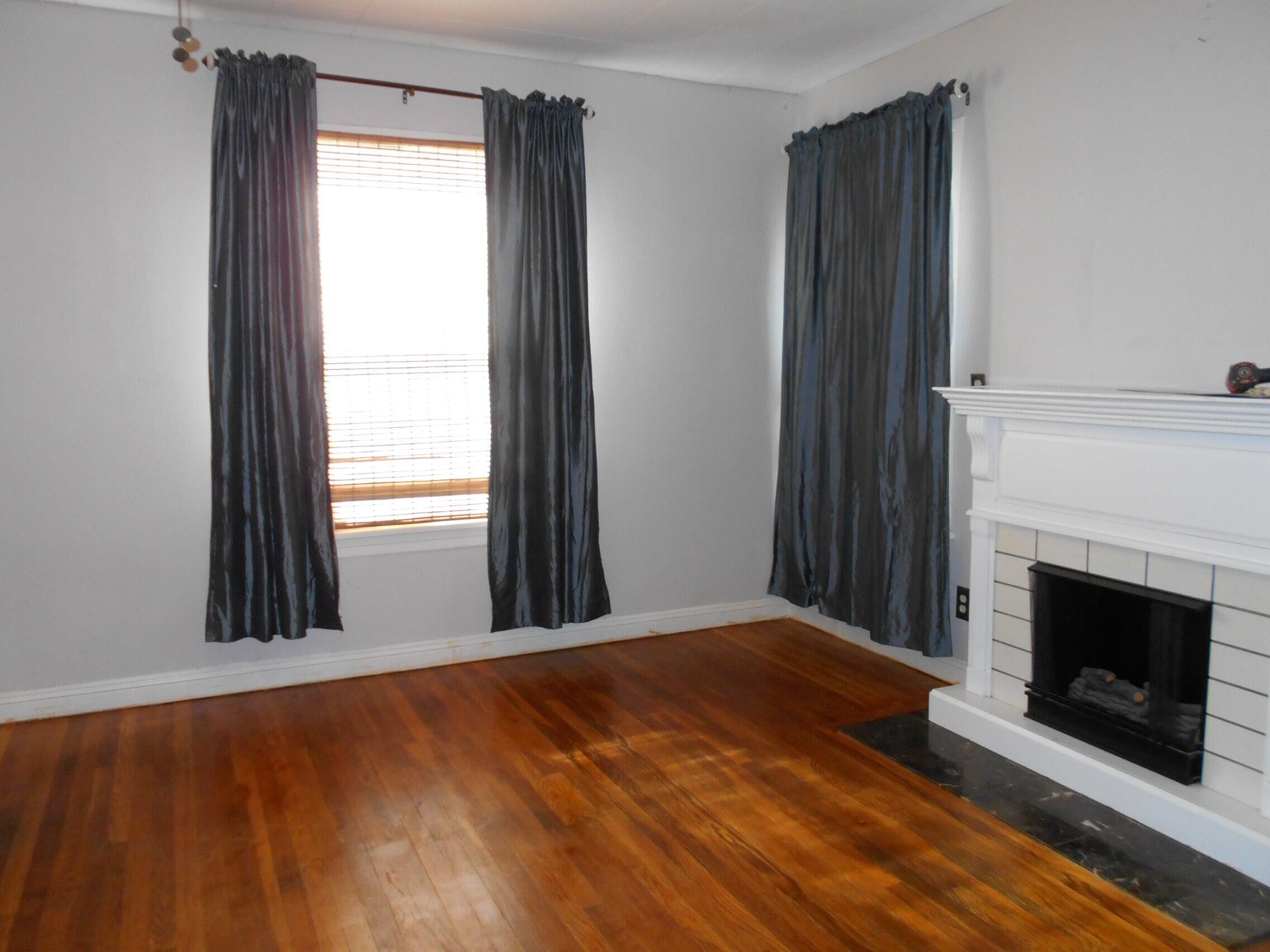 2518 25th Street Lubbock, TX 79410 - Photo 24 of 39 a view of a livingroom with an empty space and a fireplace