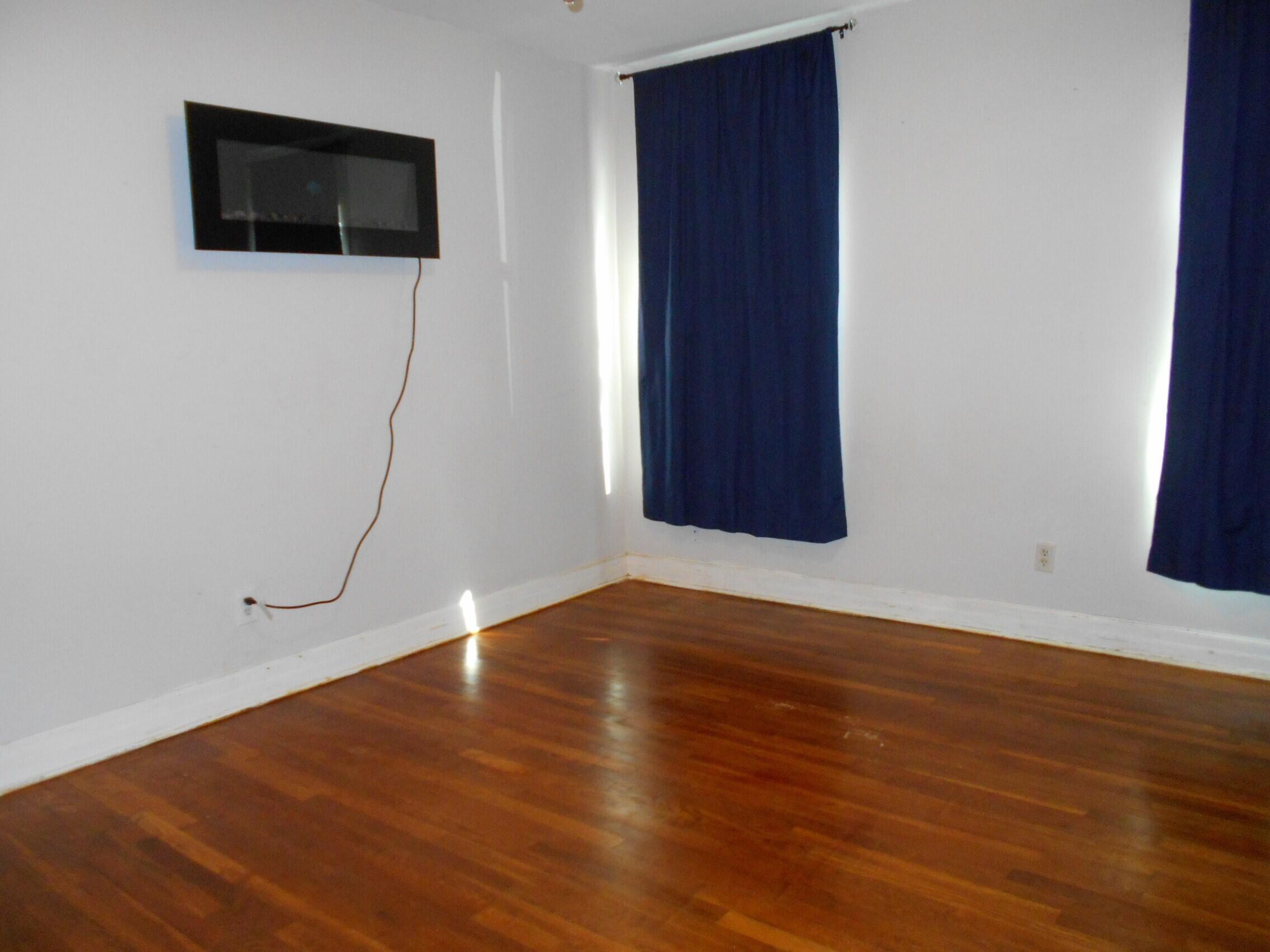 2518 25th Street Lubbock, TX 79410 - Photo 26 of 39 a view of empty room with wooden floor and fan