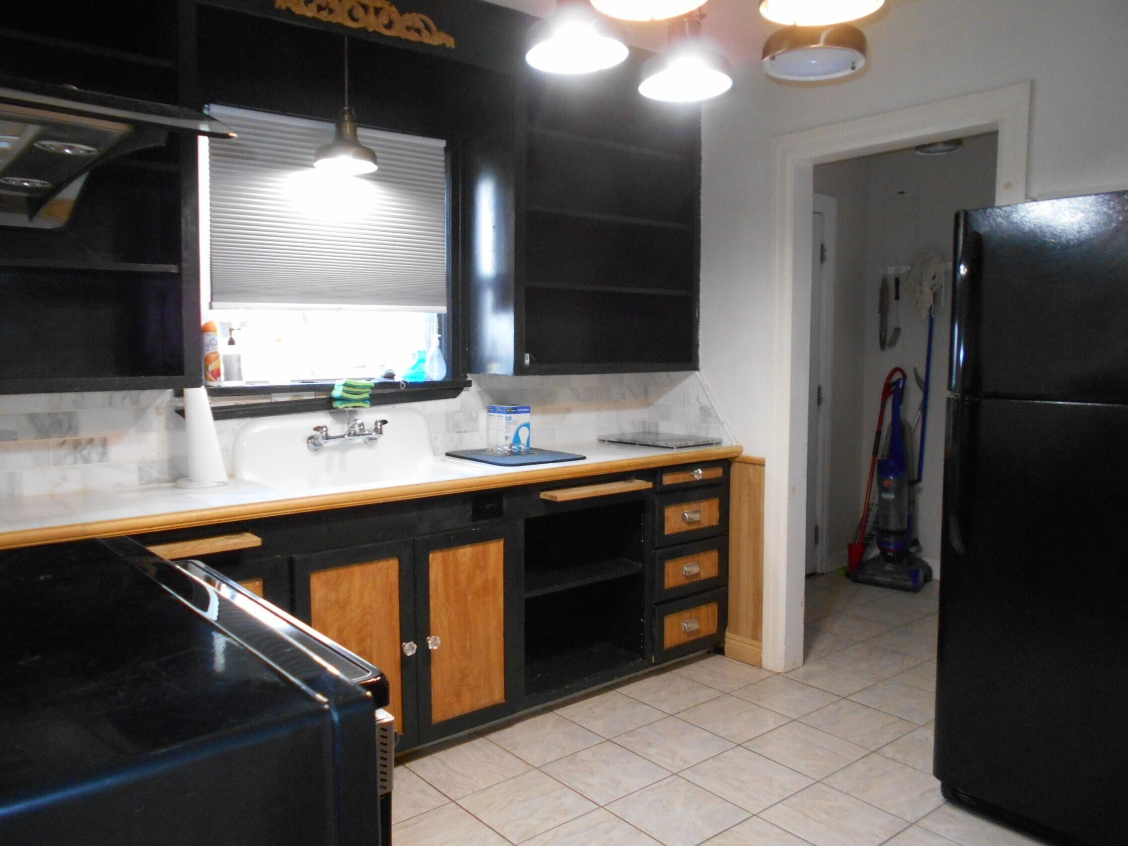 2518 25th Street Lubbock, TX 79410 - Photo 29 of 39 a kitchen with a sink appliances and cabinets