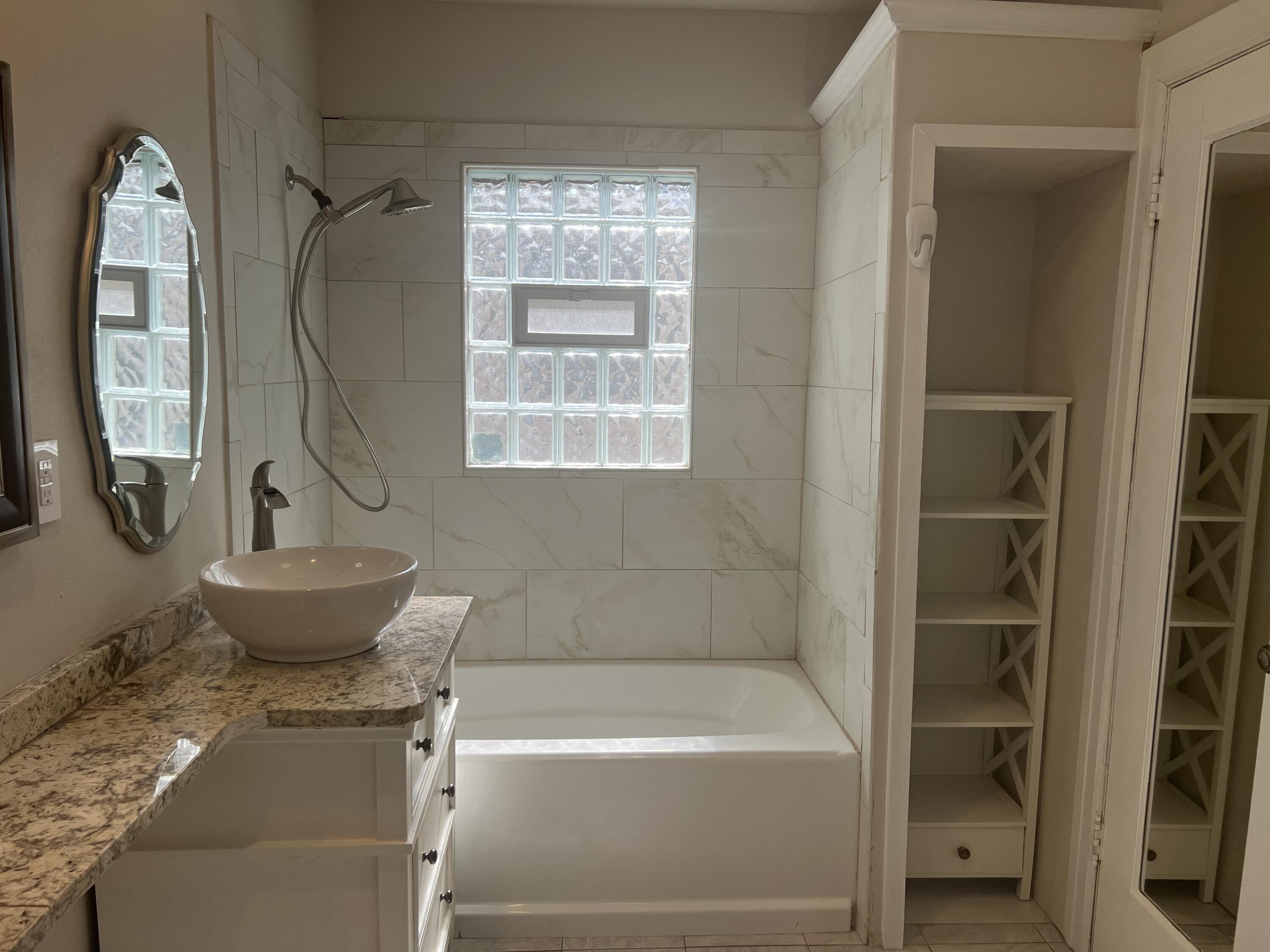 2518 25th Street Lubbock, TX 79410 - Photo 37 of 39 a bathroom with a sink toilet and shower